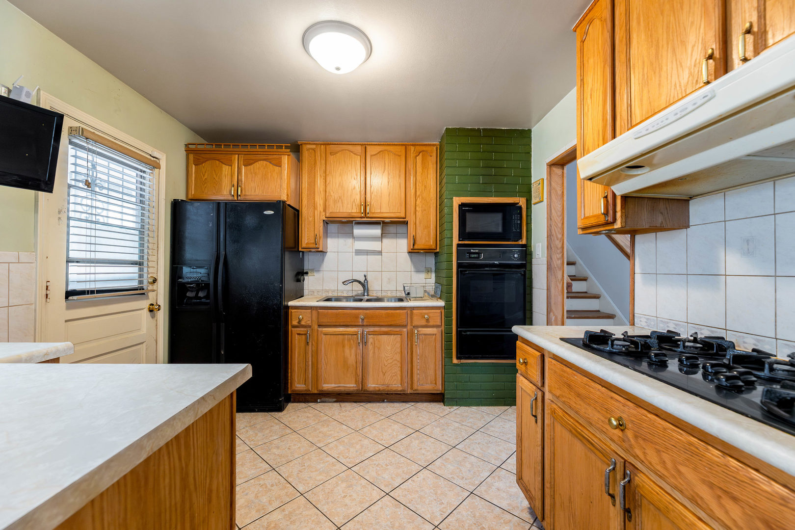 212 Berry Street Park Forest, IL 60466 - Photo 3 of 10 a kitchen with stainless steel appliances granite countertop a refrigerator and a stove top oven