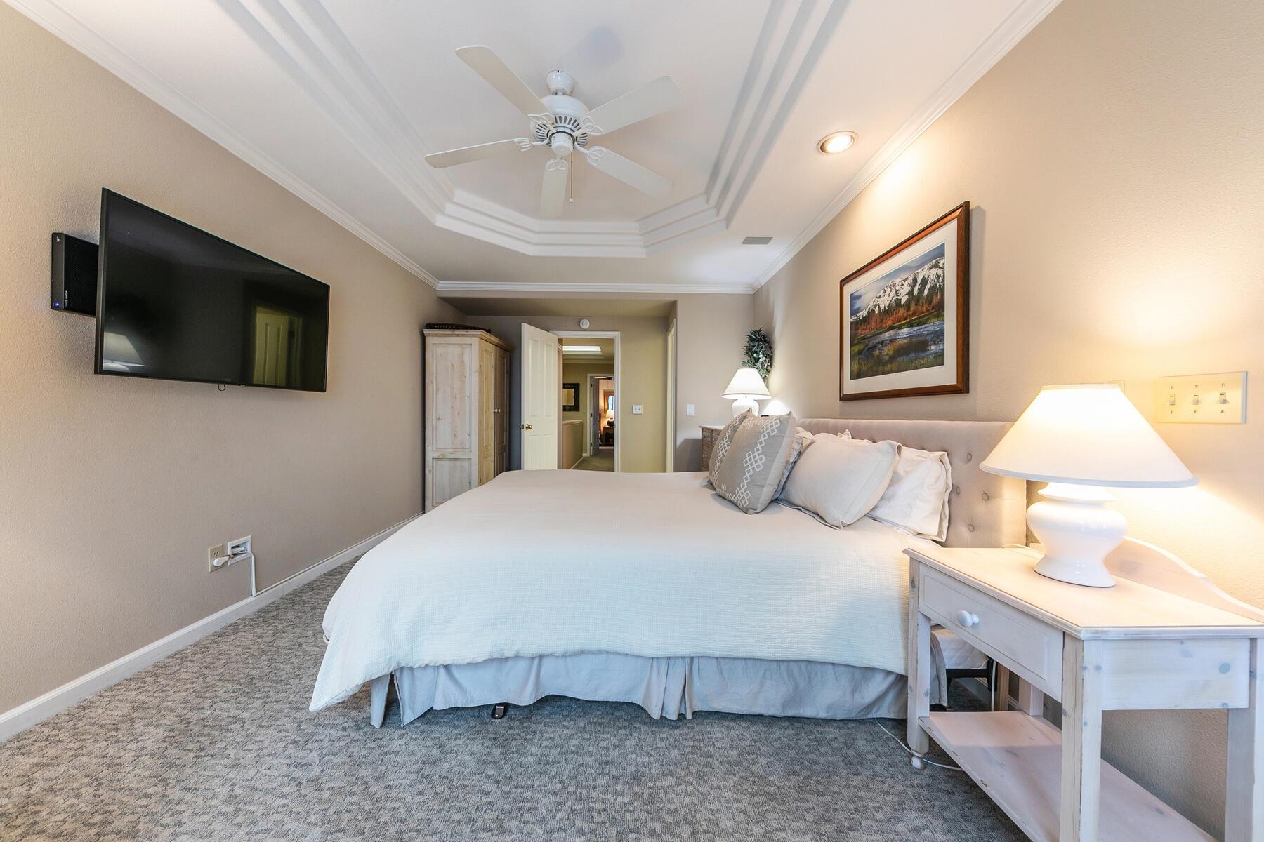 8000 North Lake Boulevard, Unit 5 Kings Beach, CA 96143 - Photo 17 of 28 a spacious bedroom with a bed and a flat screen tv