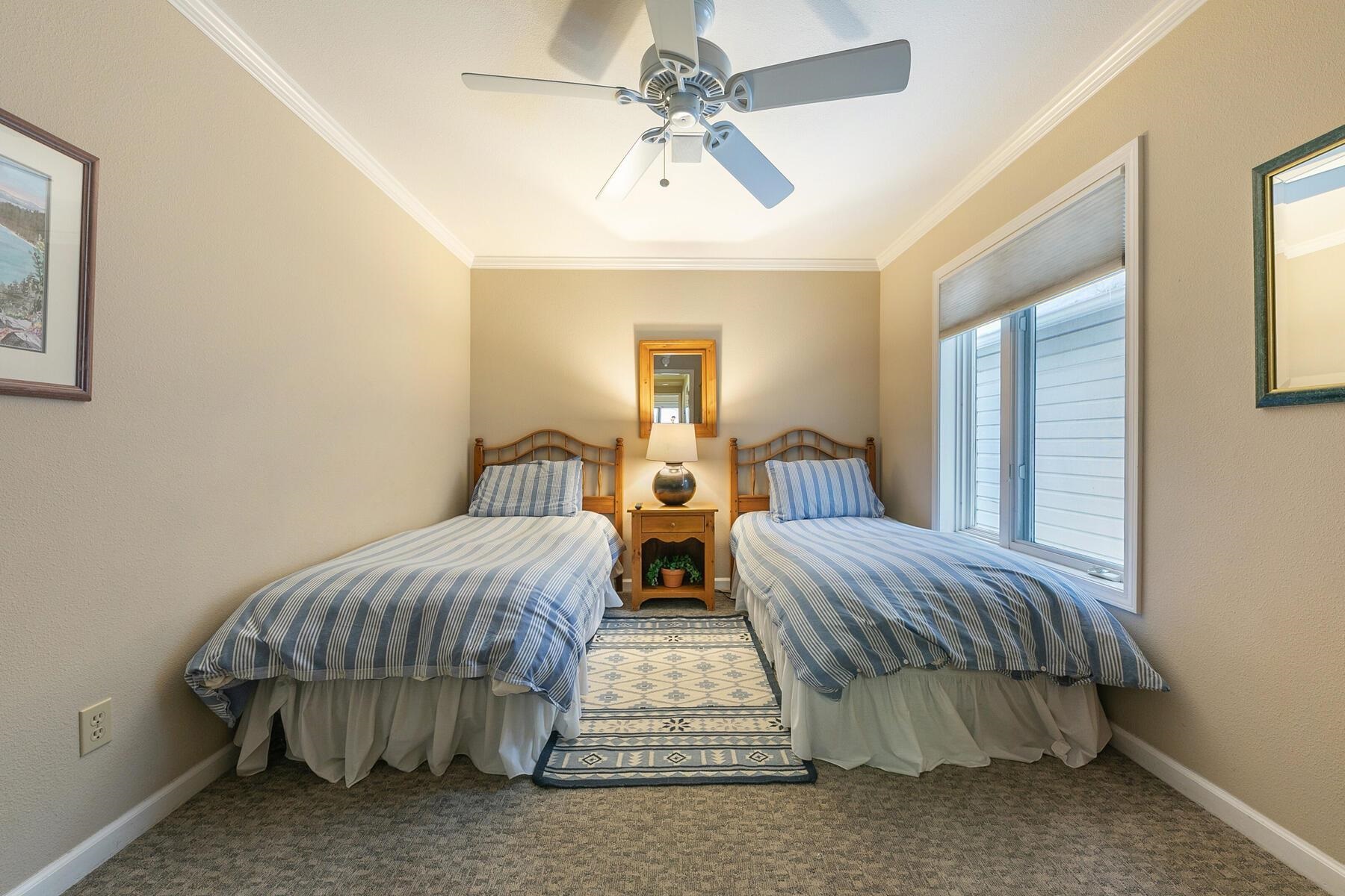 8000 North Lake Boulevard, Unit 5 Kings Beach, CA 96143 - Photo 20 of 28 a bedroom with two beds and a chandelier