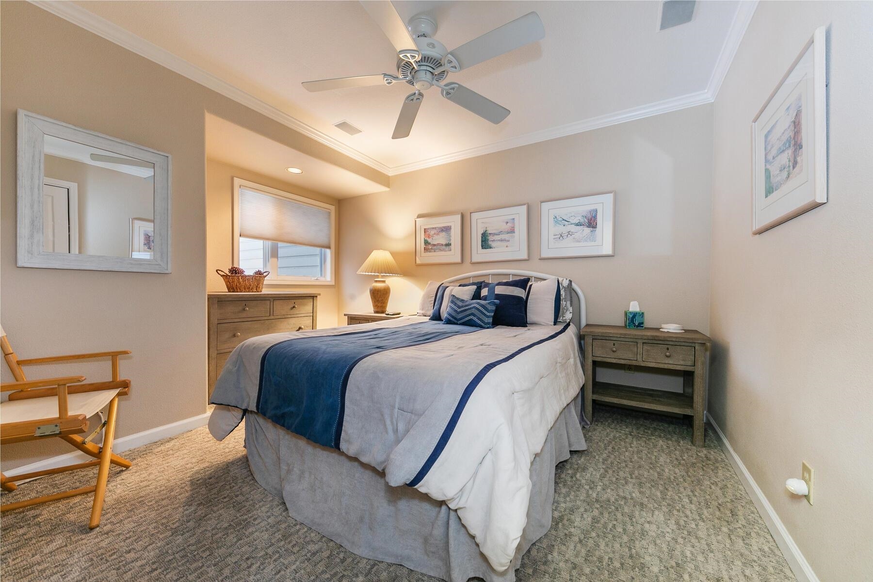 8000 North Lake Boulevard, Unit 5 Kings Beach, CA 96143 - Photo 22 of 28 a bedroom with a bed and a chandelier