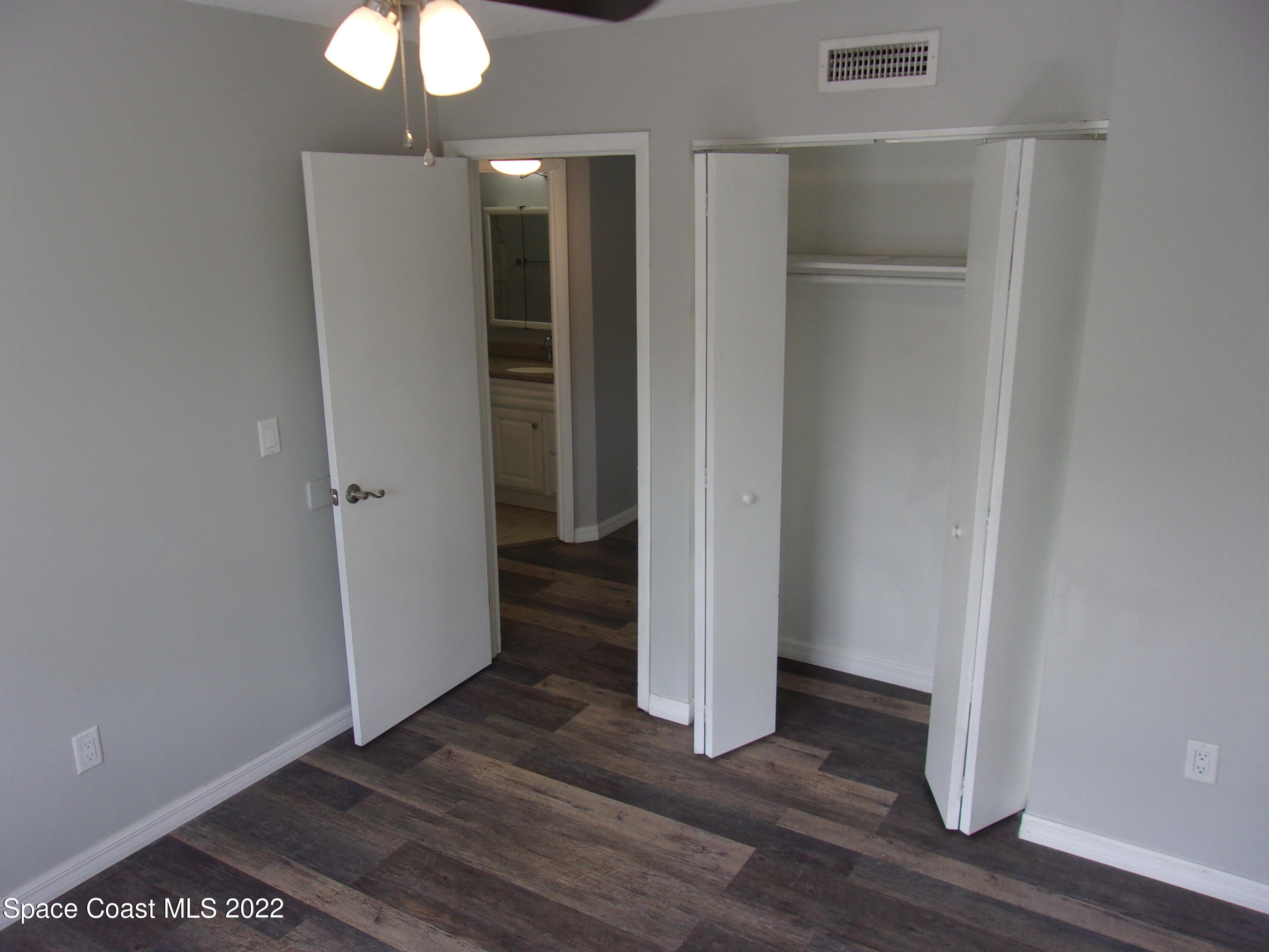 1050 North Fiske Boulevard, Unit 406 Cocoa, FL 32922 - Photo 6 of 11 a view of a hallway with wooden floor