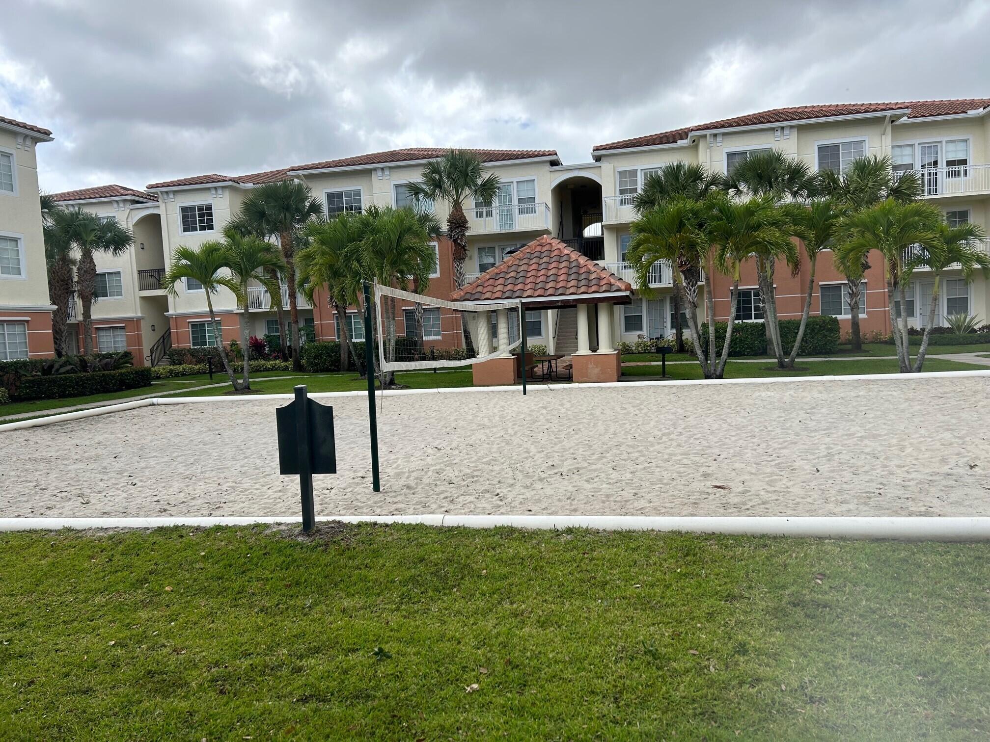 9825 Baywinds Boulevard, Unit 1206 Royal Palm Beach, FL 33411 - Photo 11 of 22 a front view of a house with a yard