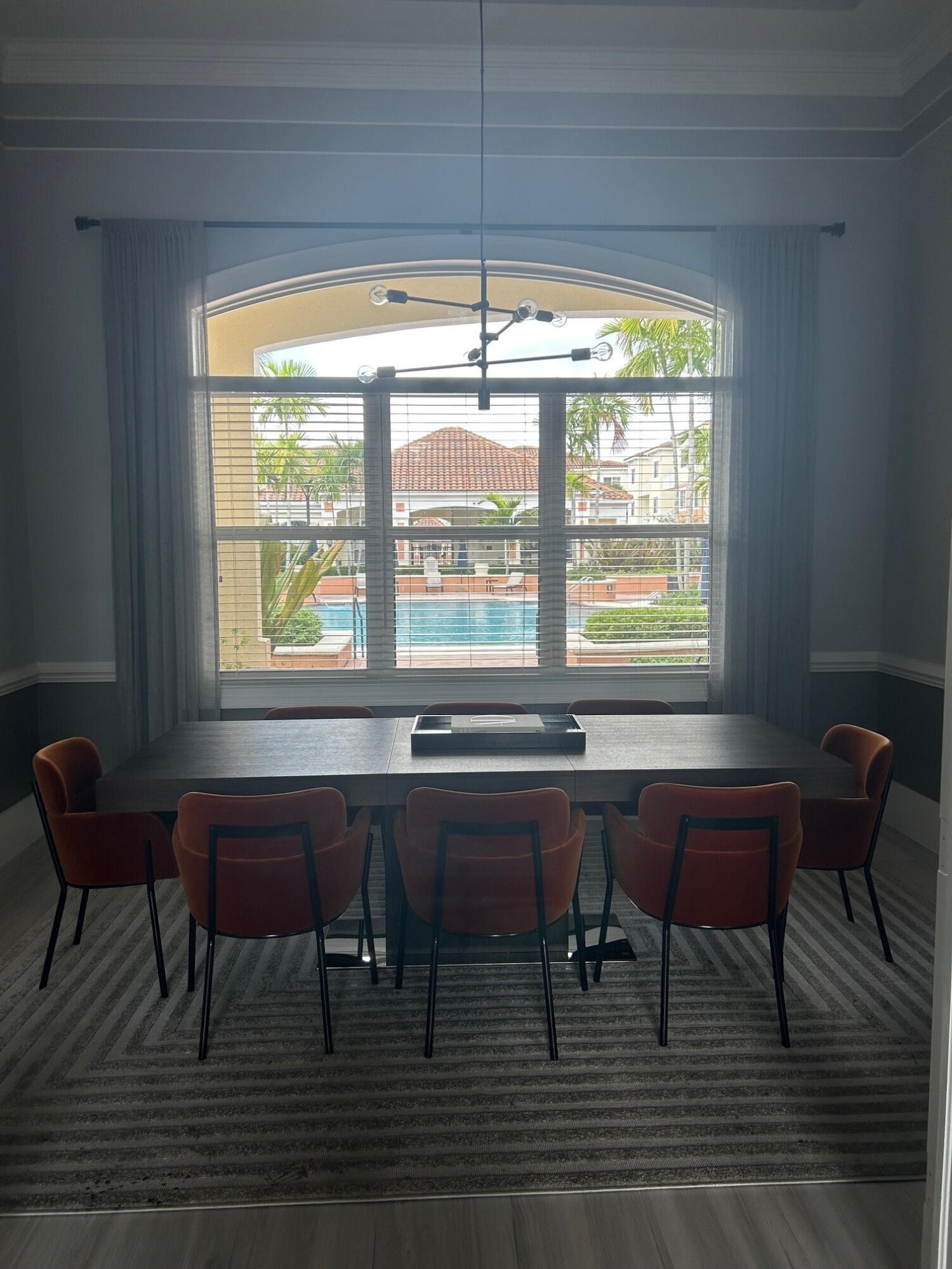 9825 Baywinds Boulevard, Unit 1206 Royal Palm Beach, FL 33411 - Photo 18 of 22 a room with a table and chairs