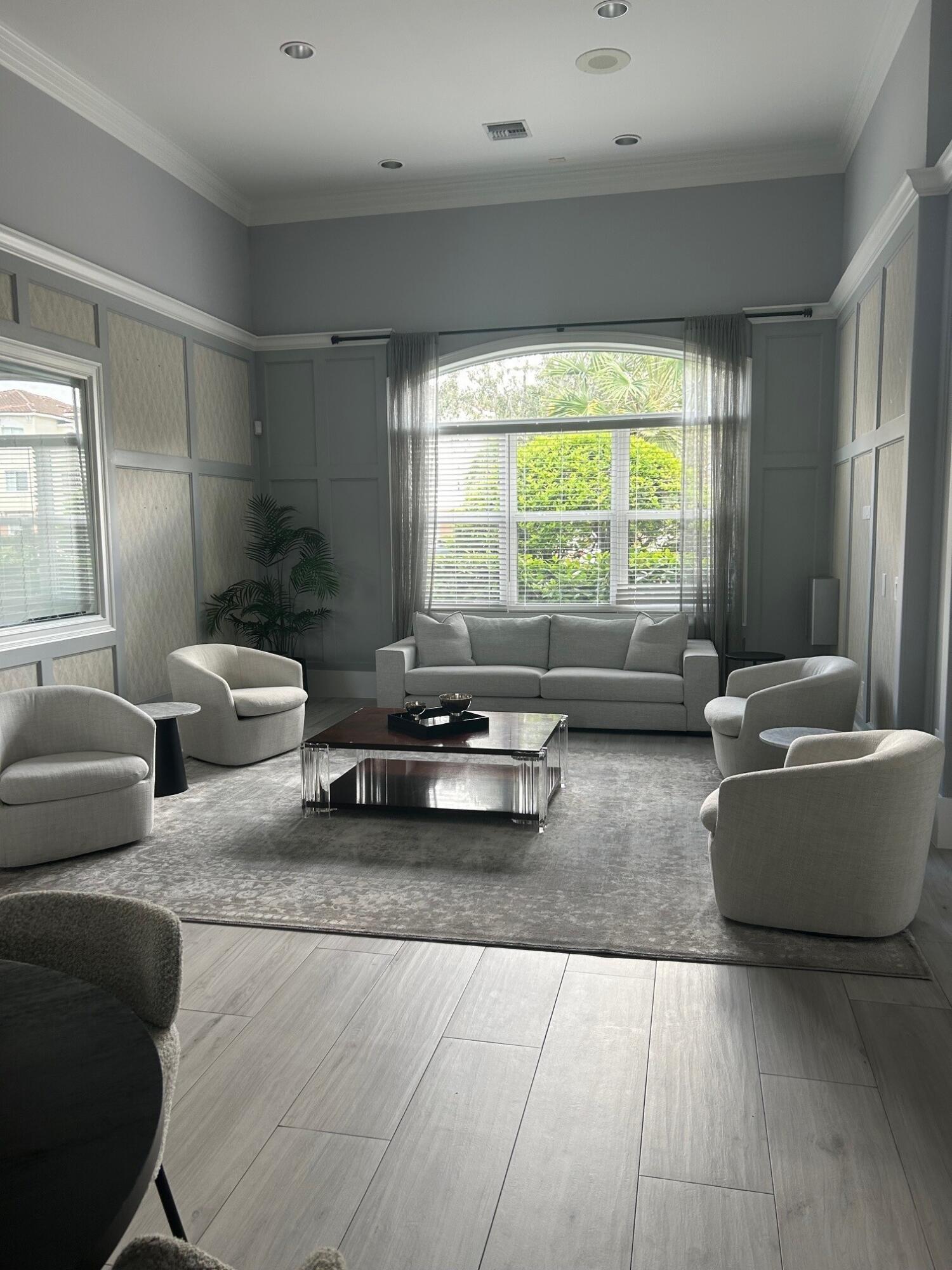 9825 Baywinds Boulevard, Unit 1206 Royal Palm Beach, FL 33411 - Photo 19 of 22 a living room with furniture and a large window