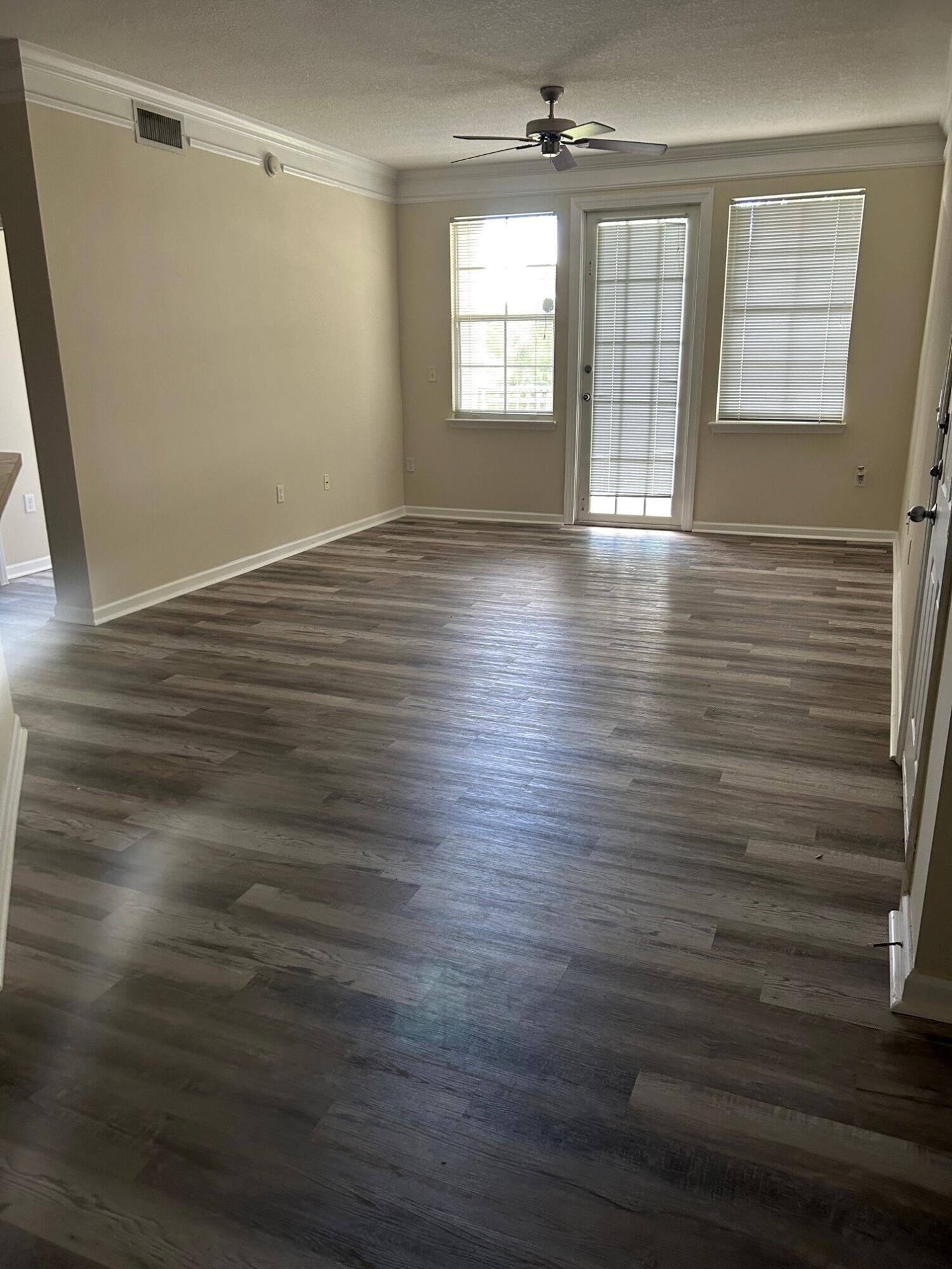 9825 Baywinds Boulevard, Unit 1206 Royal Palm Beach, FL 33411 - Photo 2 of 22 wooden floor in an empty room with a window