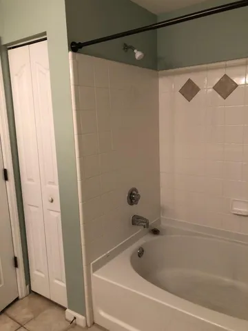 a bathroom with a shower and a bath tub