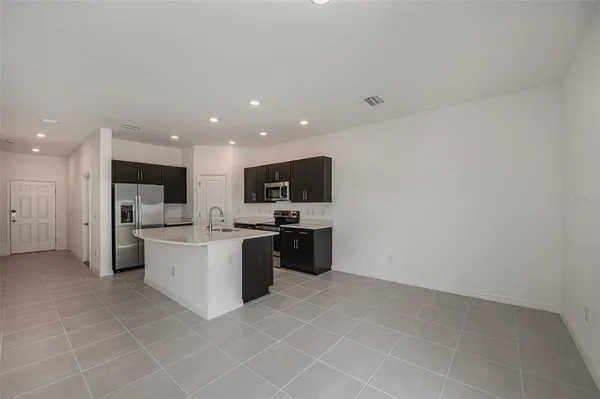a large white kitchen with a large window