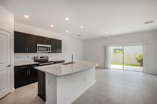 a kitchen with a sink a stove and cabinets