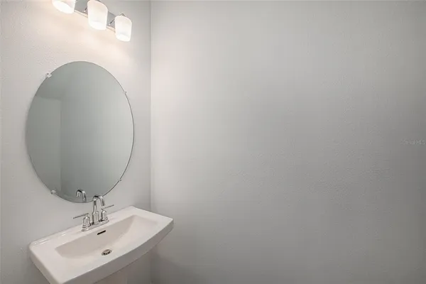 a bathroom with a sink and mirror