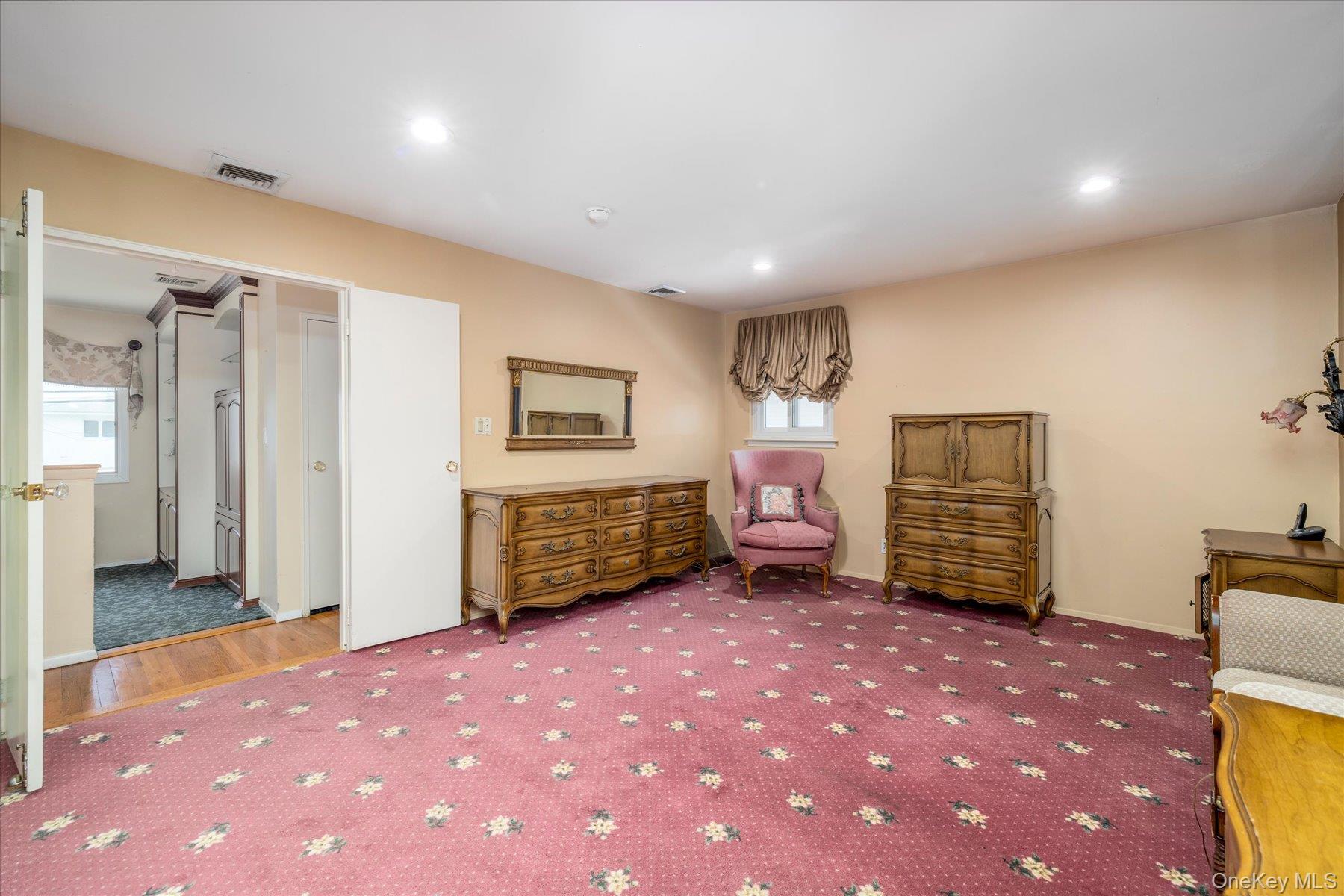 3284 Shore Road Oceanside, NY 11572 - Photo 14 of 27 a spacious bedroom with a bed and a cabinets