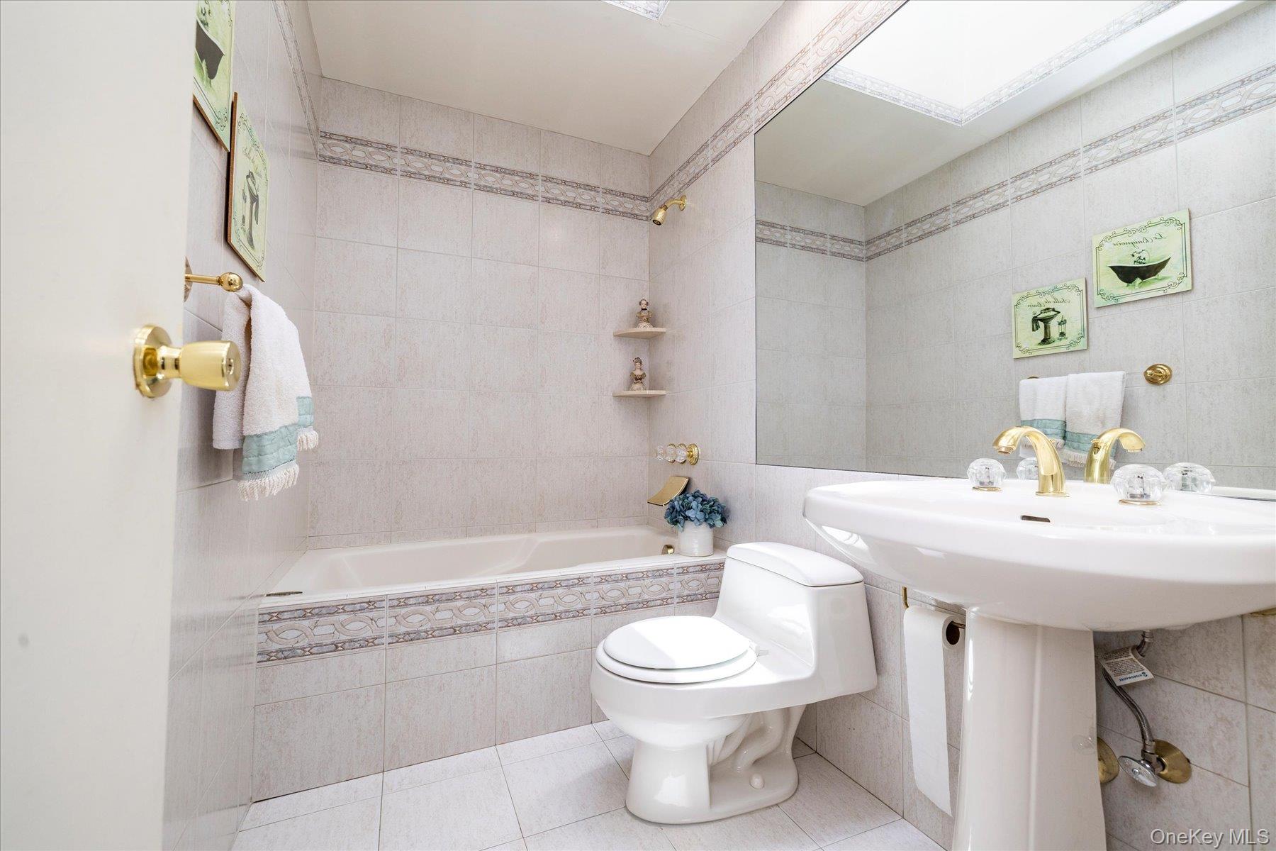 3284 Shore Road Oceanside, NY 11572 - Photo 16 of 27 a bathroom with a sink toilet and shower