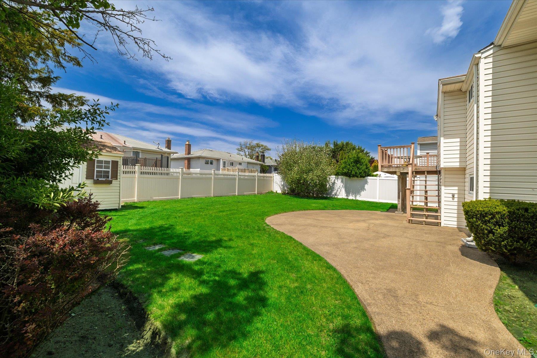 3284 Shore Road Oceanside, NY 11572 - Photo 21 of 27 a view of a house with a yard and plants