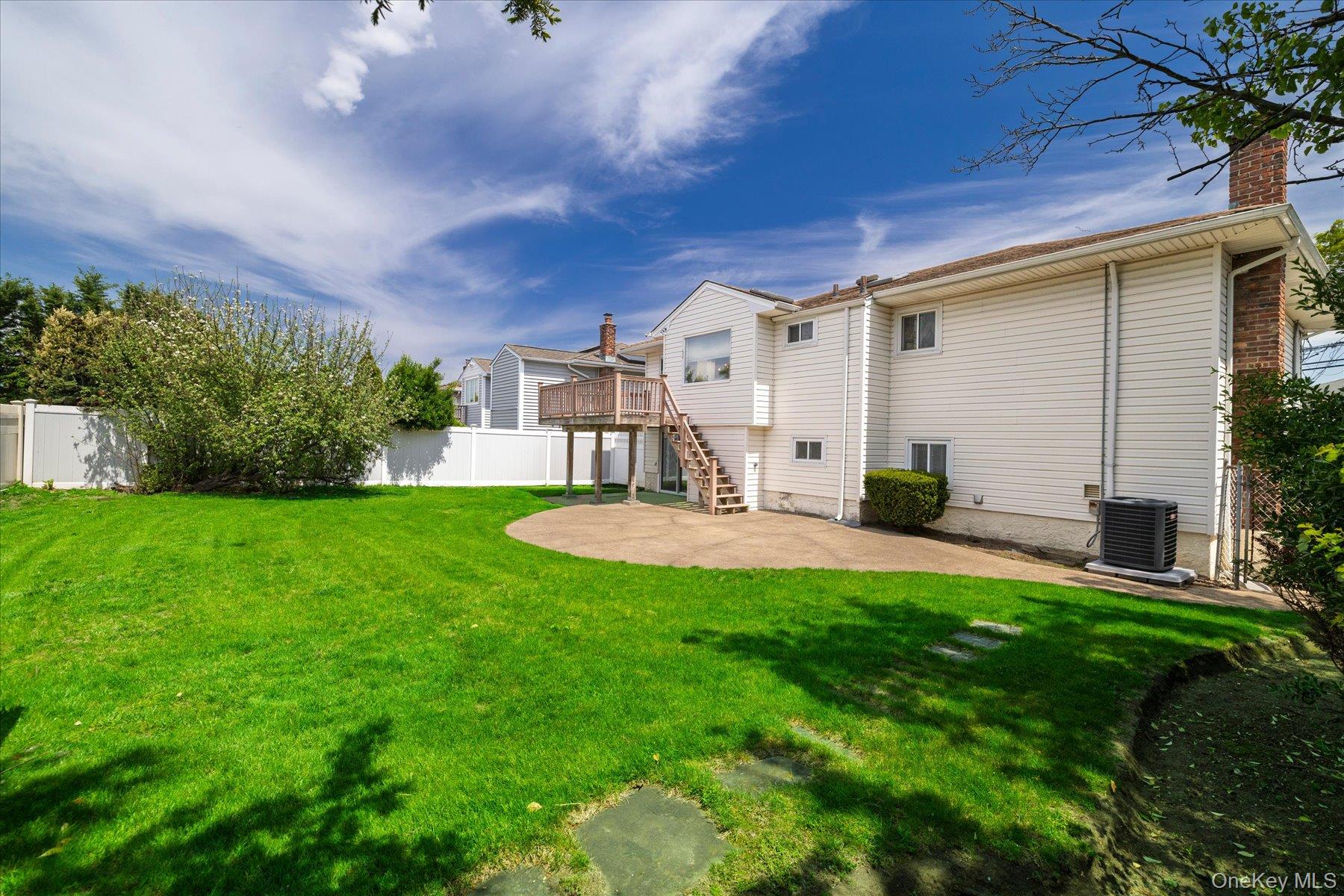 3284 Shore Road Oceanside, NY 11572 - Photo 22 of 27 a view of a house with a backyard