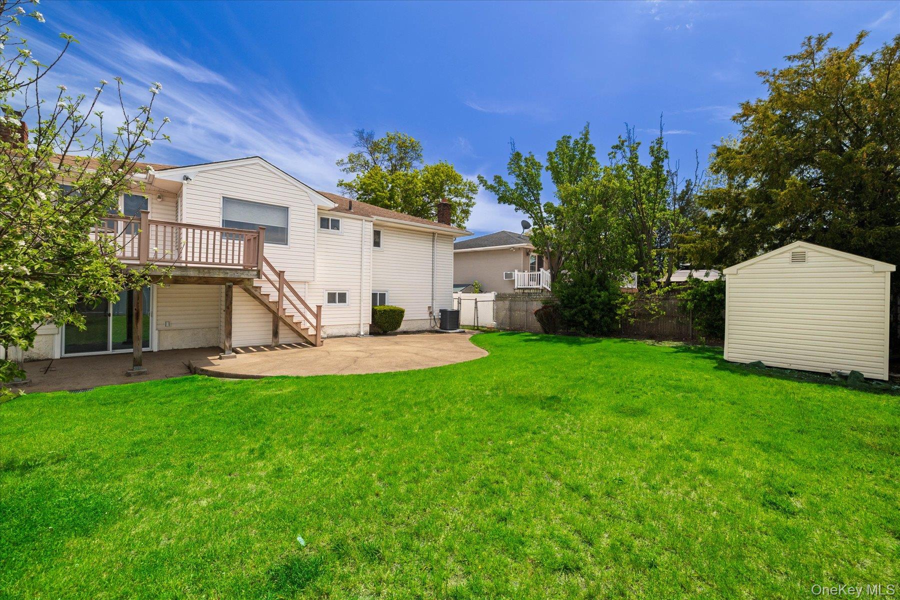 3284 Shore Road Oceanside, NY 11572 - Photo 23 of 27 a view of a house with backyard and a tree