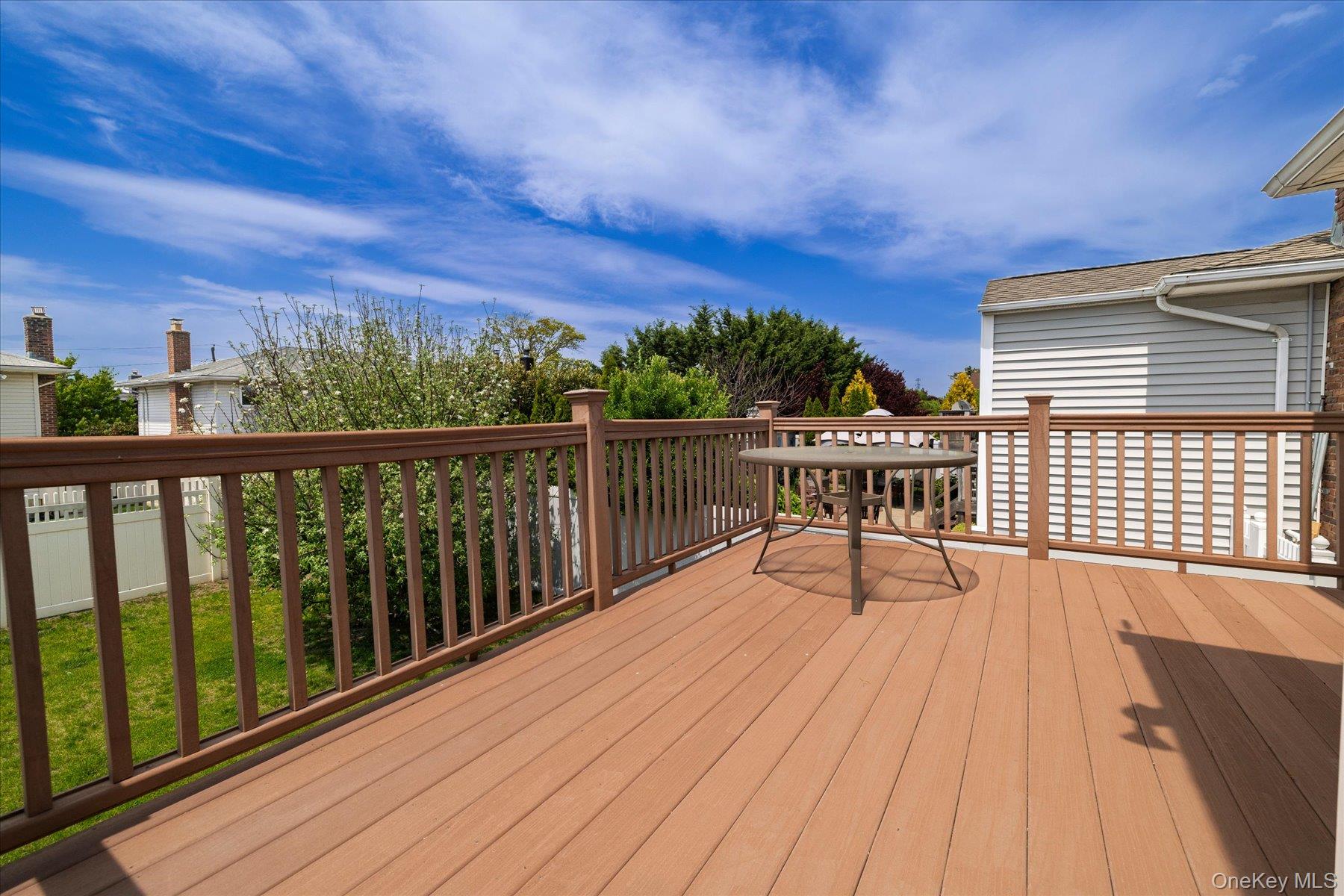 3284 Shore Road Oceanside, NY 11572 - Photo 24 of 27 a view of balcony with wooden floor and outdoor seating