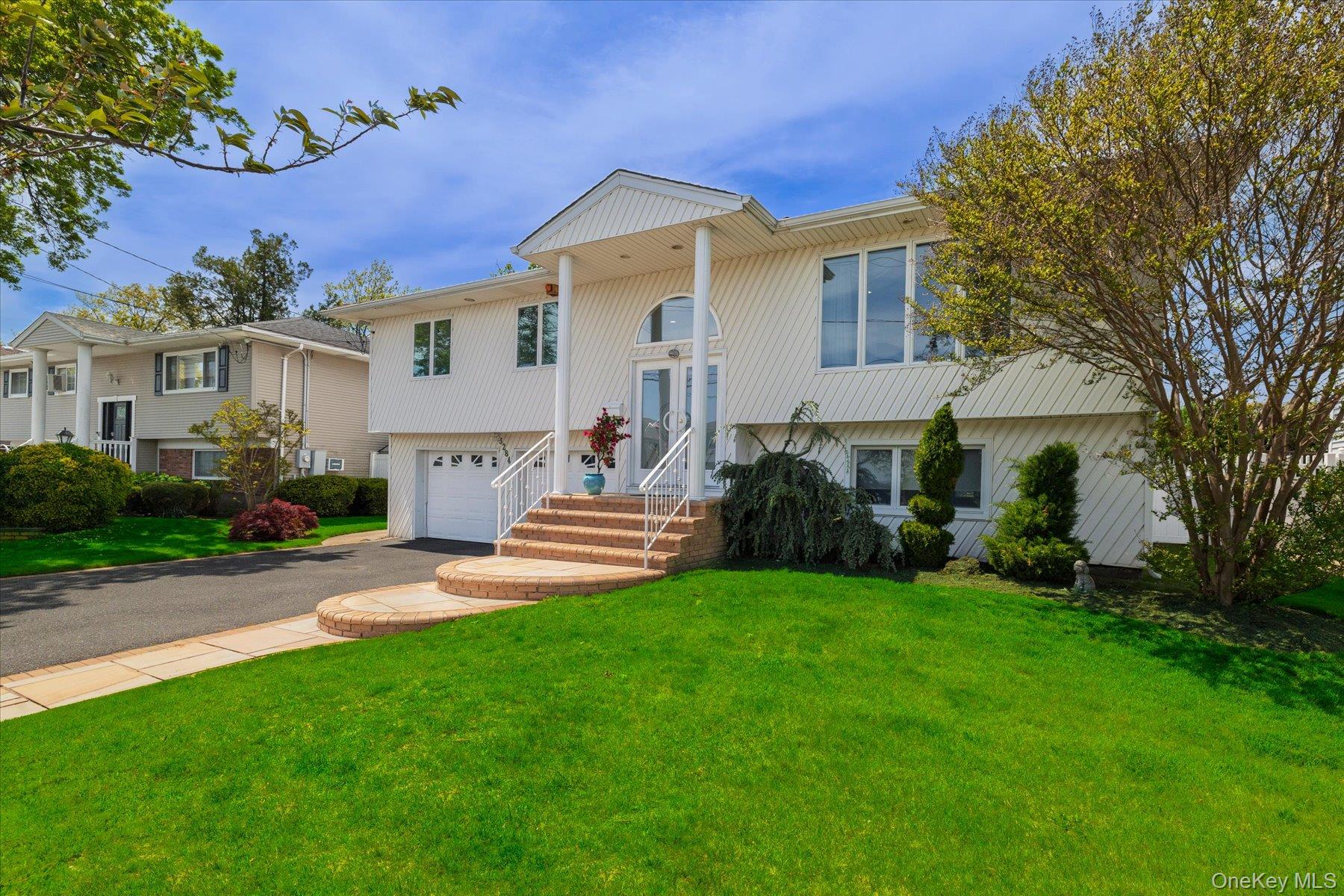 3284 Shore Road Oceanside, NY 11572 - Photo 27 of 27 a view of a house with a yard and sitting area