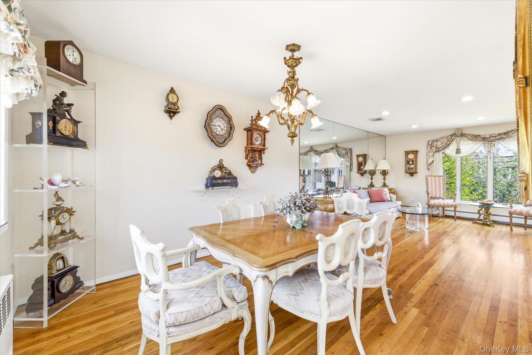 3284 Shore Road Oceanside, NY 11572 - Photo 7 of 27 a view of a dining room with furniture a chandelier and wooden floor