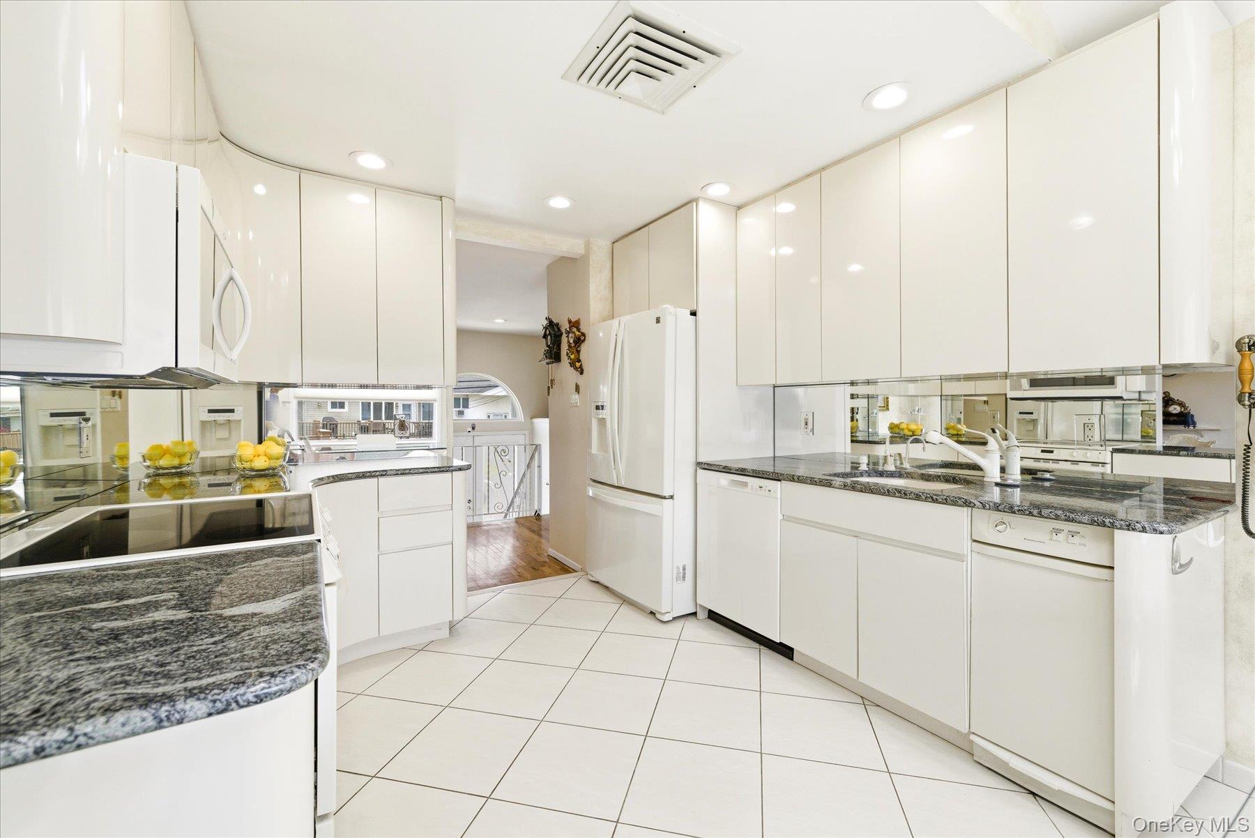 3284 Shore Road Oceanside, NY 11572 - Photo 10 of 27 a kitchen with stainless steel appliances granite countertop a sink and cabinets
