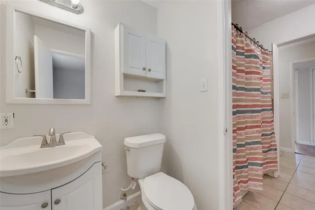 a white toilet sitting next to a bathroom sink