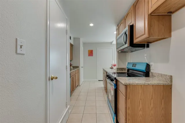 a kitchen with stainless steel appliances granite countertop a stove top oven a sink and dishwasher