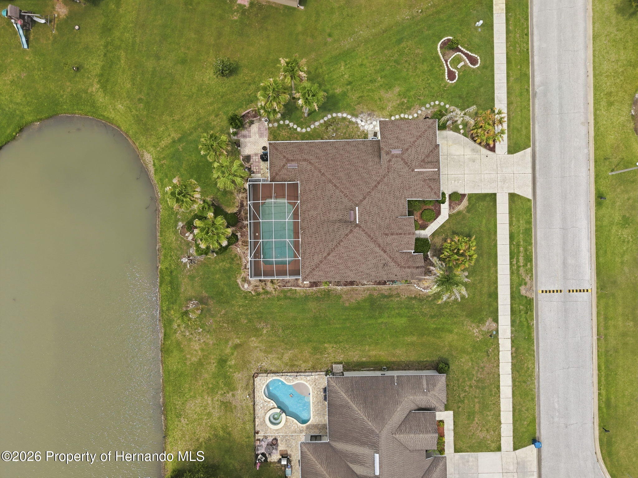 18131 Rivard Boulevard Brooksville, FL 34604 - Photo 63 of 66 an aerial view of a house with a yard