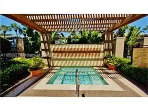 a view of a swimming pool with potted plants