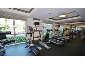 a living room with gym equipment and a large window
