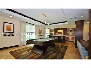 a living room with furniture a flat screen tv and a table