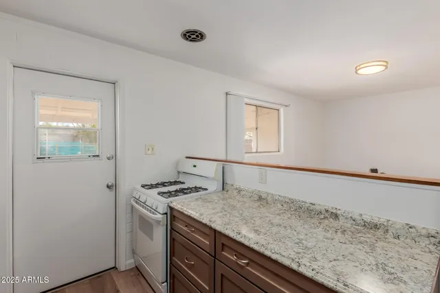 a kitchen with a stove and a refrigerator