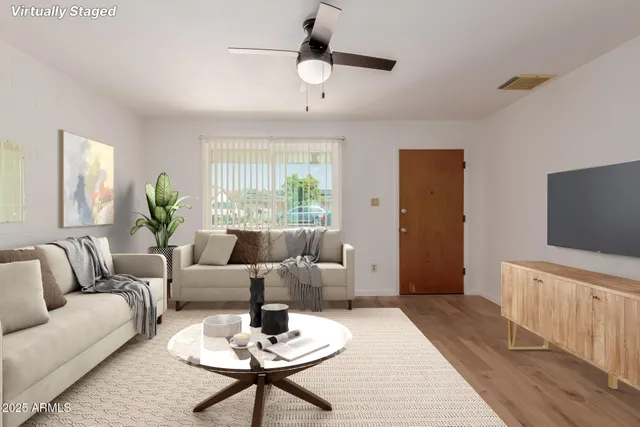 a living room with furniture and a flat screen tv