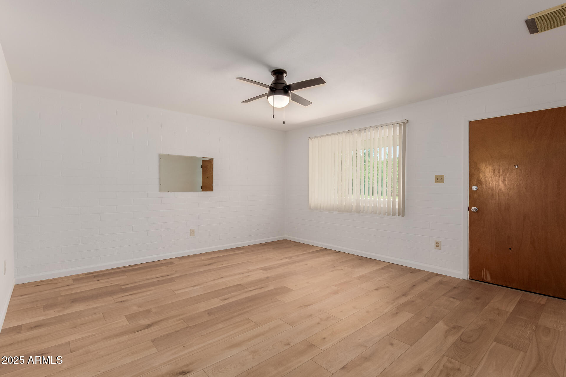 10012 North 16th Drive Phoenix, AZ 85021 - Photo 7 of 39 an empty room with fan and windows
