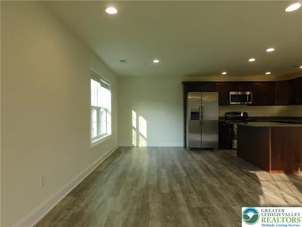 a kitchen with a refrigerator and a sink
