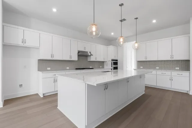 a kitchen with kitchen island white cabinets and white appliances