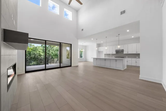 a view of a kitchen with large windows and a fireplace