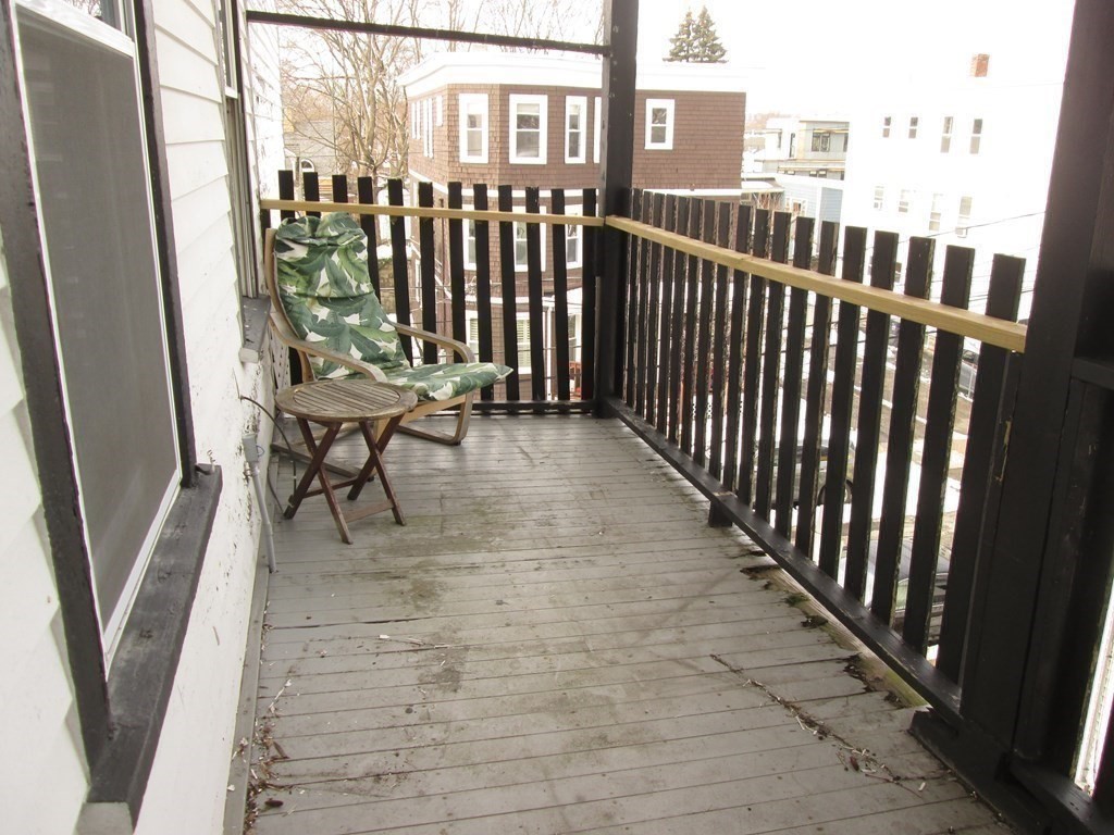 7-9 Reed Street Cambridge, MA 02140 - Photo 18 of 41 a view of a balcony with chair and wooden fence