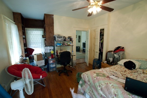 7-9 Reed Street Cambridge, MA 02140 - Photo 34 of 41 a bedroom with a bed and a chandelier