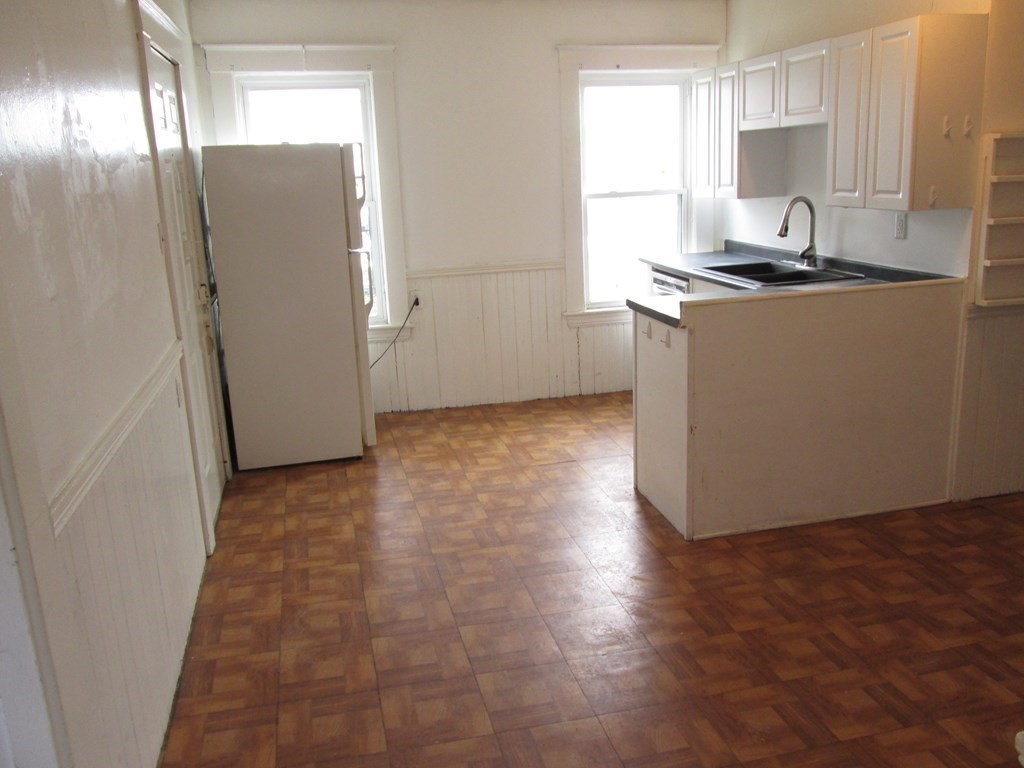 7-9 Reed Street Cambridge, MA 02140 - Photo 6 of 41 a kitchen with granite countertop a sink a stove a refrigerator and cabinets