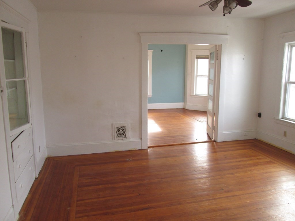 7-9 Reed Street Cambridge, MA 02140 - Photo 8 of 41 an empty room with wooden floor and windows