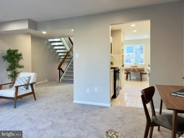 a view of a livingroom with furniture and a potted plant