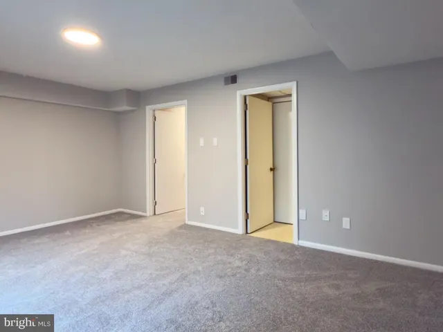 an empty room with closet area