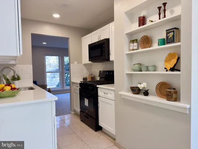 a kitchen with stainless steel appliances granite countertop a sink and a microwave