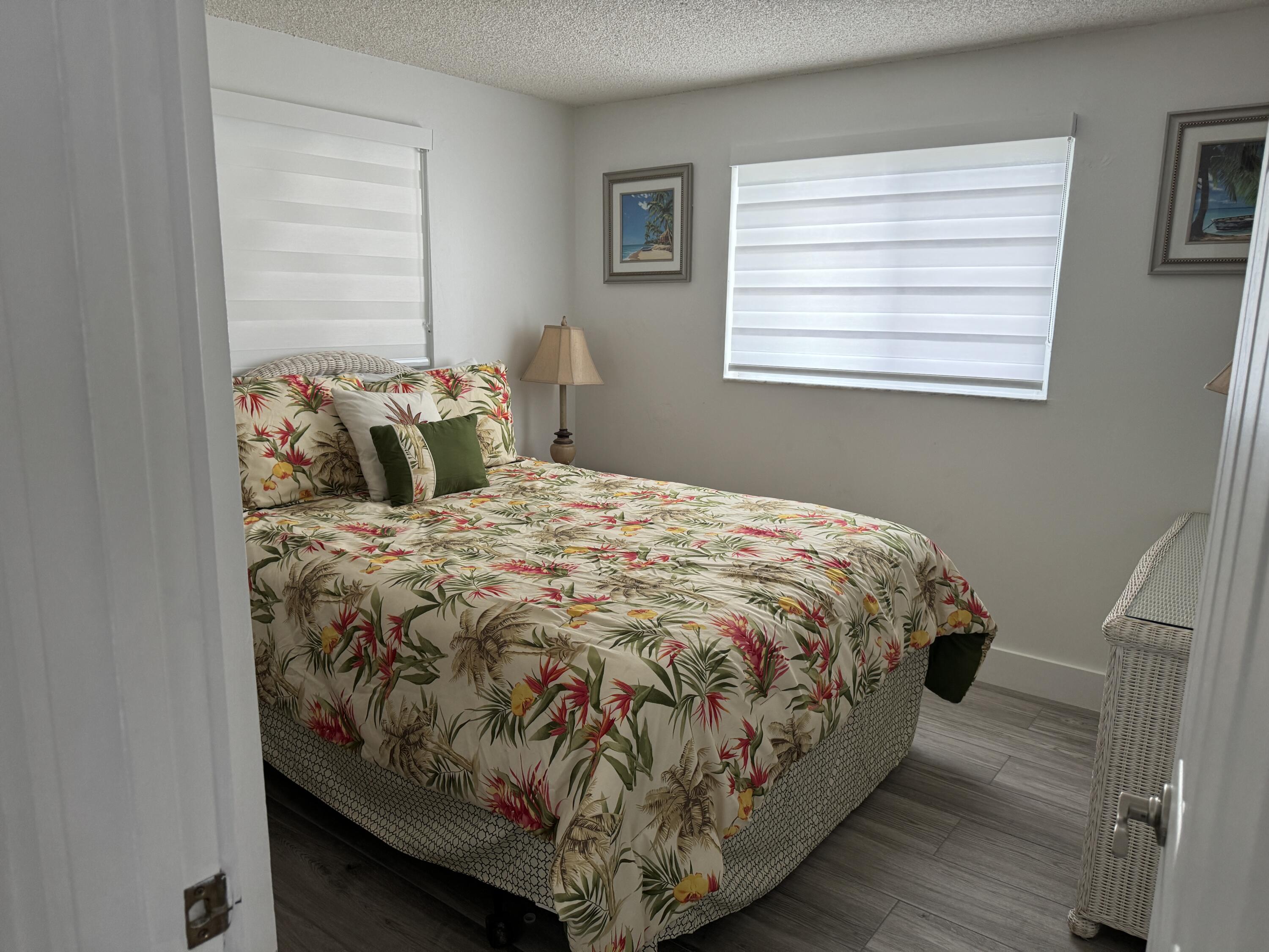 176 Lorelane Place Key Largo, FL 33037 - Photo 13 of 20 a bed sitting in a bedroom next to a window