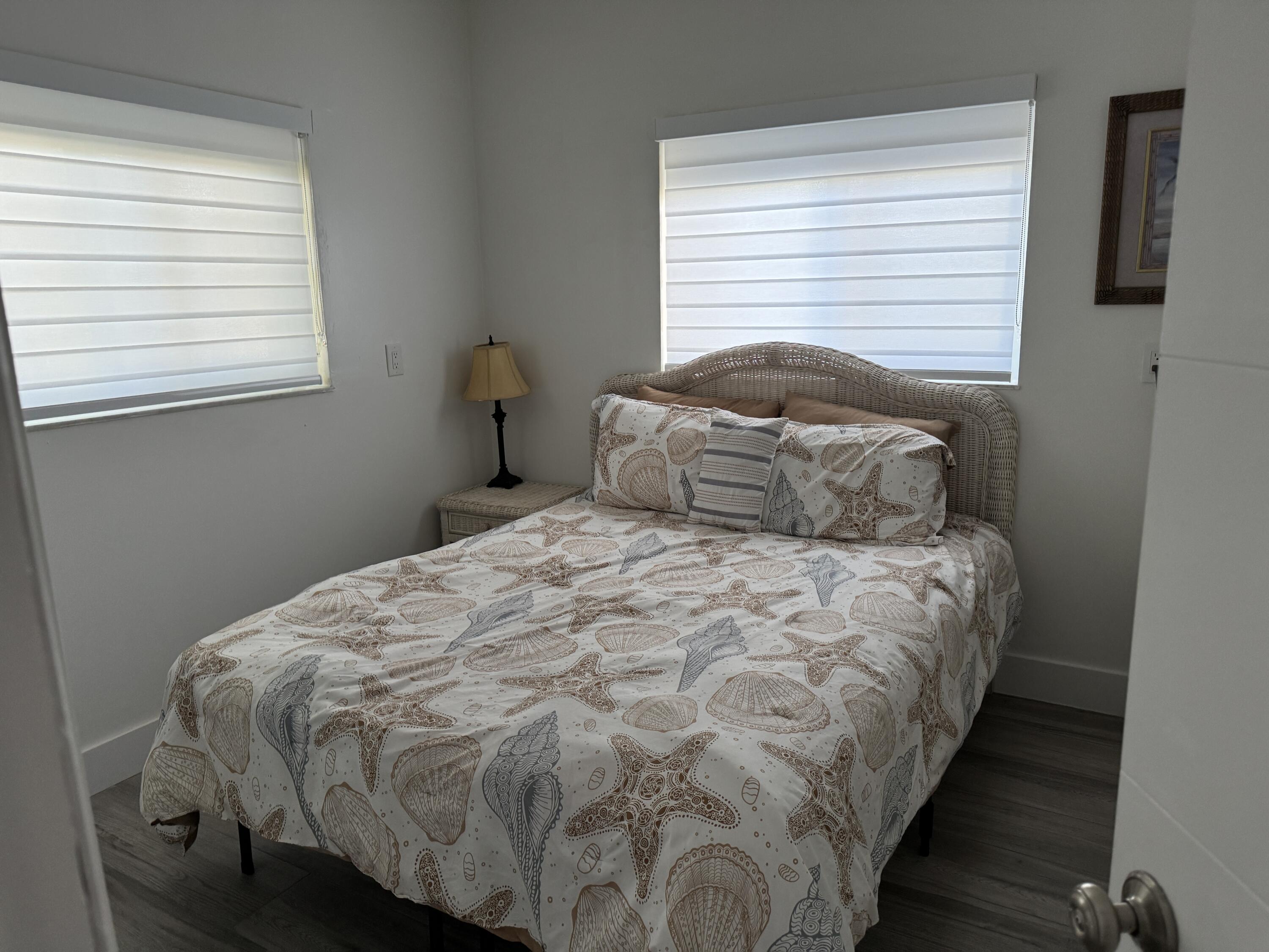 176 Lorelane Place Key Largo, FL 33037 - Photo 18 of 20 a bedroom with a bed and a window