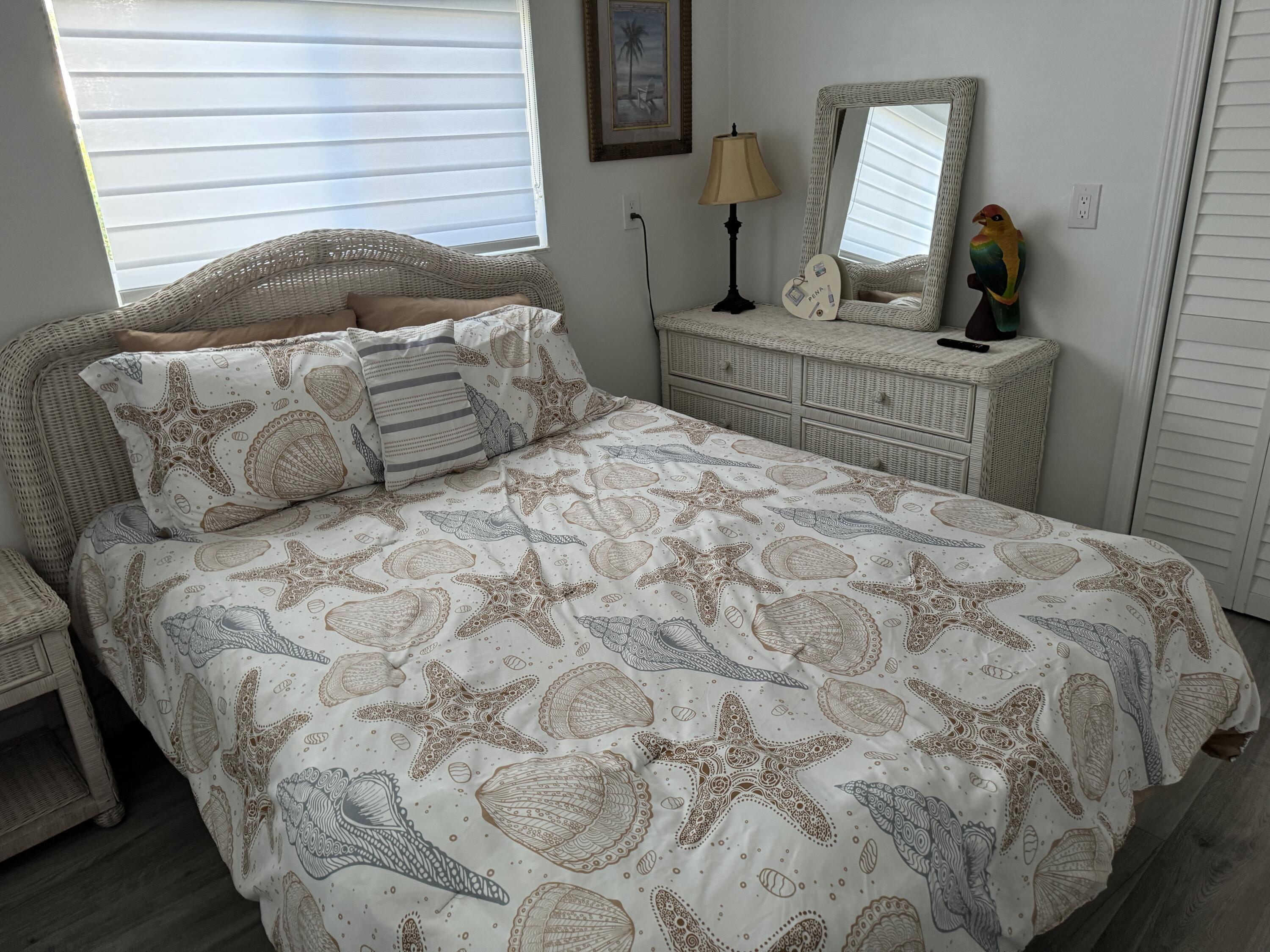 176 Lorelane Place Key Largo, FL 33037 - Photo 19 of 20 a bedroom with a bed a computer on the desk and mirror
