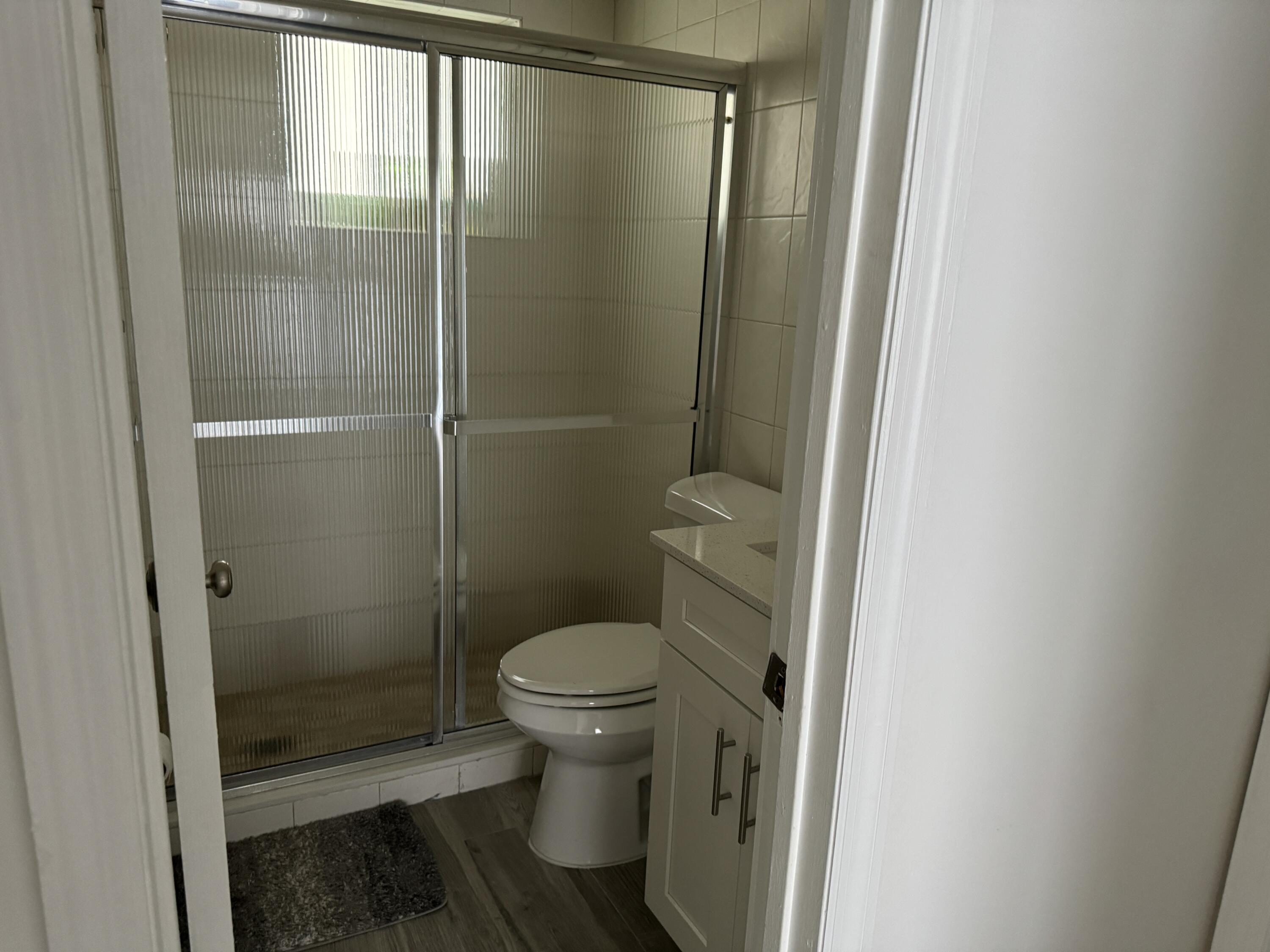 176 Lorelane Place Key Largo, FL 33037 - Photo 20 of 20 a bathroom with a granite countertop toilet and a shower