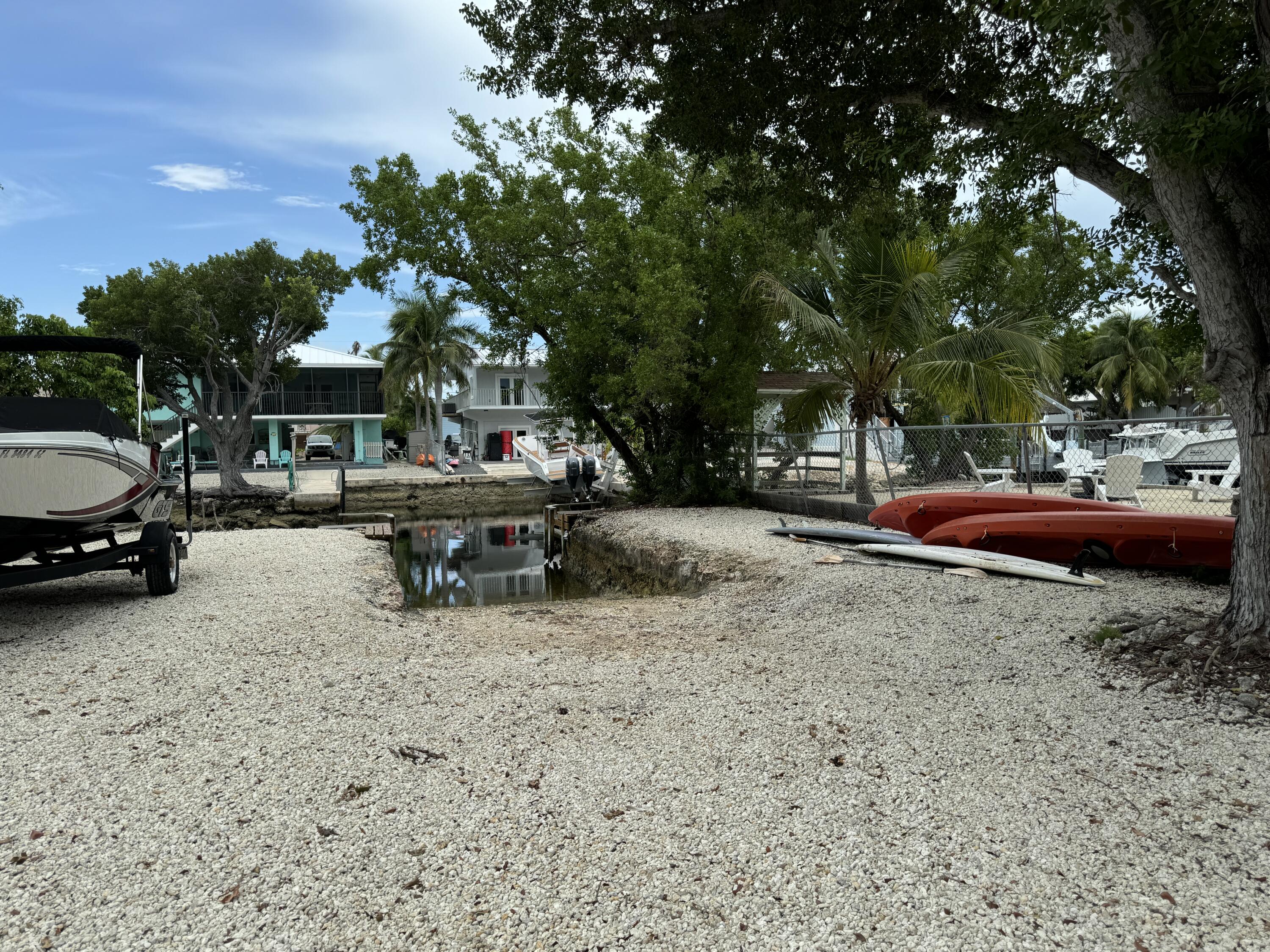 176 Lorelane Place Key Largo, FL 33037 - Photo 2 of 20 a view of a yard with cars on road