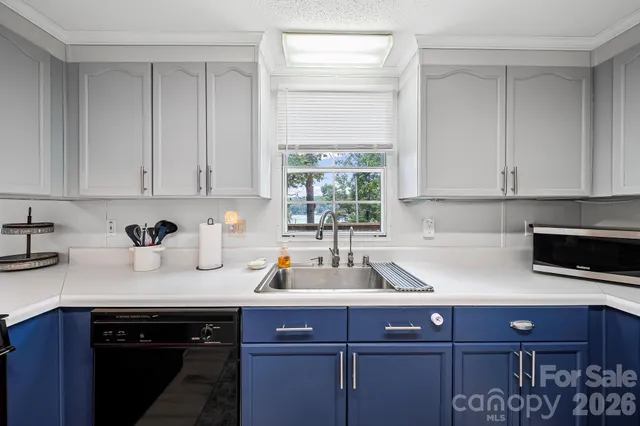 a kitchen with a sink cabinets and window