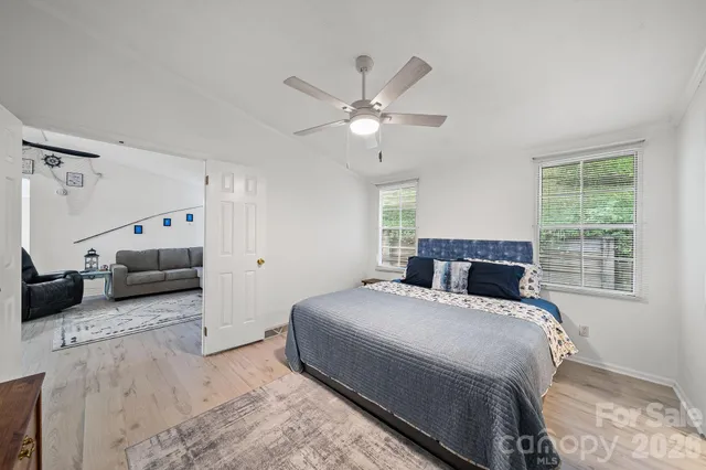 a bedroom with a large bed and a window