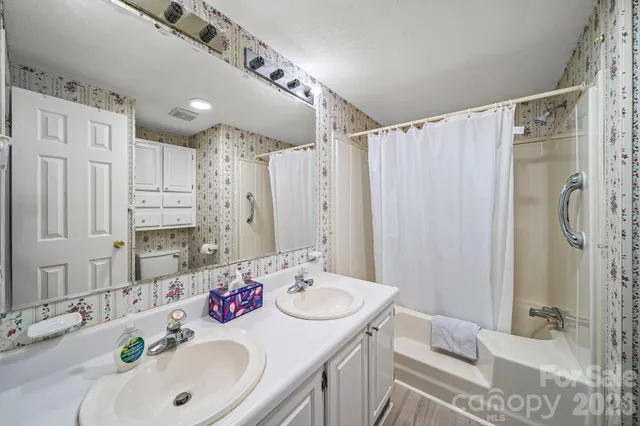 a bathroom with a sink double vanity and shower