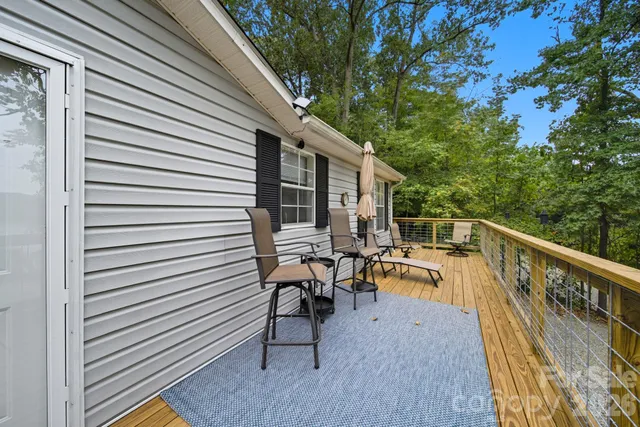 a view of a patio with chairs and table in the deck